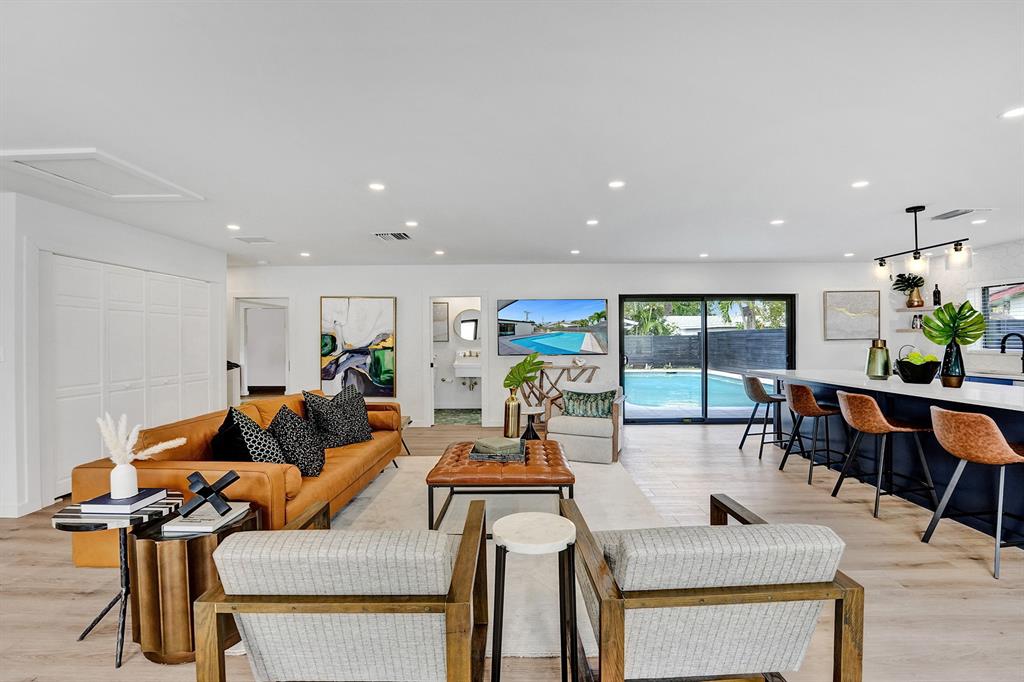 5501 Northeast 18th Terrace Fort Lauderdale, FL 33308 - Photo 29 of 56 a living room with furniture a rug and white walls