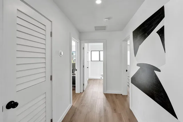 a living room with a large window and furniture