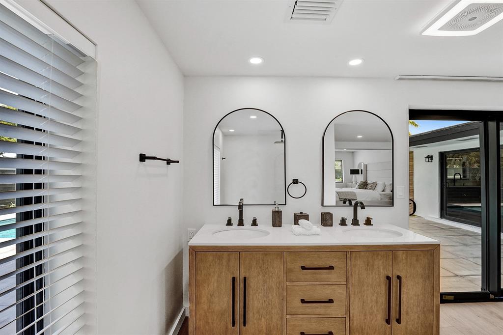 5501 Northeast 18th Terrace Fort Lauderdale, FL 33308 - Photo 32 of 56 a bathroom with a double vanity sink and a mirror