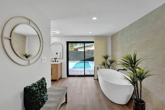 a large living room with stainless steel appliances kitchen island a table chairs and a counter top space