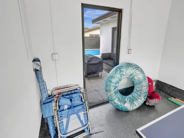 a view of a backyard with swimming pool