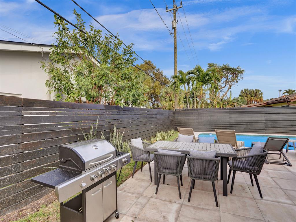 5501 Northeast 18th Terrace Fort Lauderdale, FL 33308 - Photo 48 of 56 a view of a patio with table and chairs and potted plants
