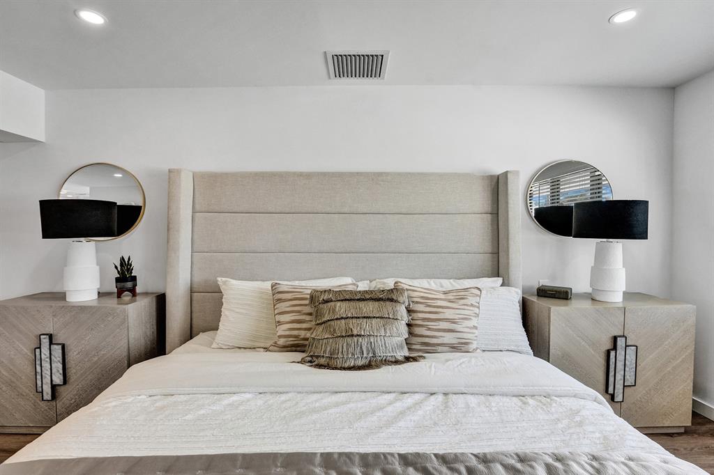 5501 Northeast 18th Terrace Fort Lauderdale, FL 33308 - Photo 10 of 56 a bedroom with a bed a couch and a flat screen tv