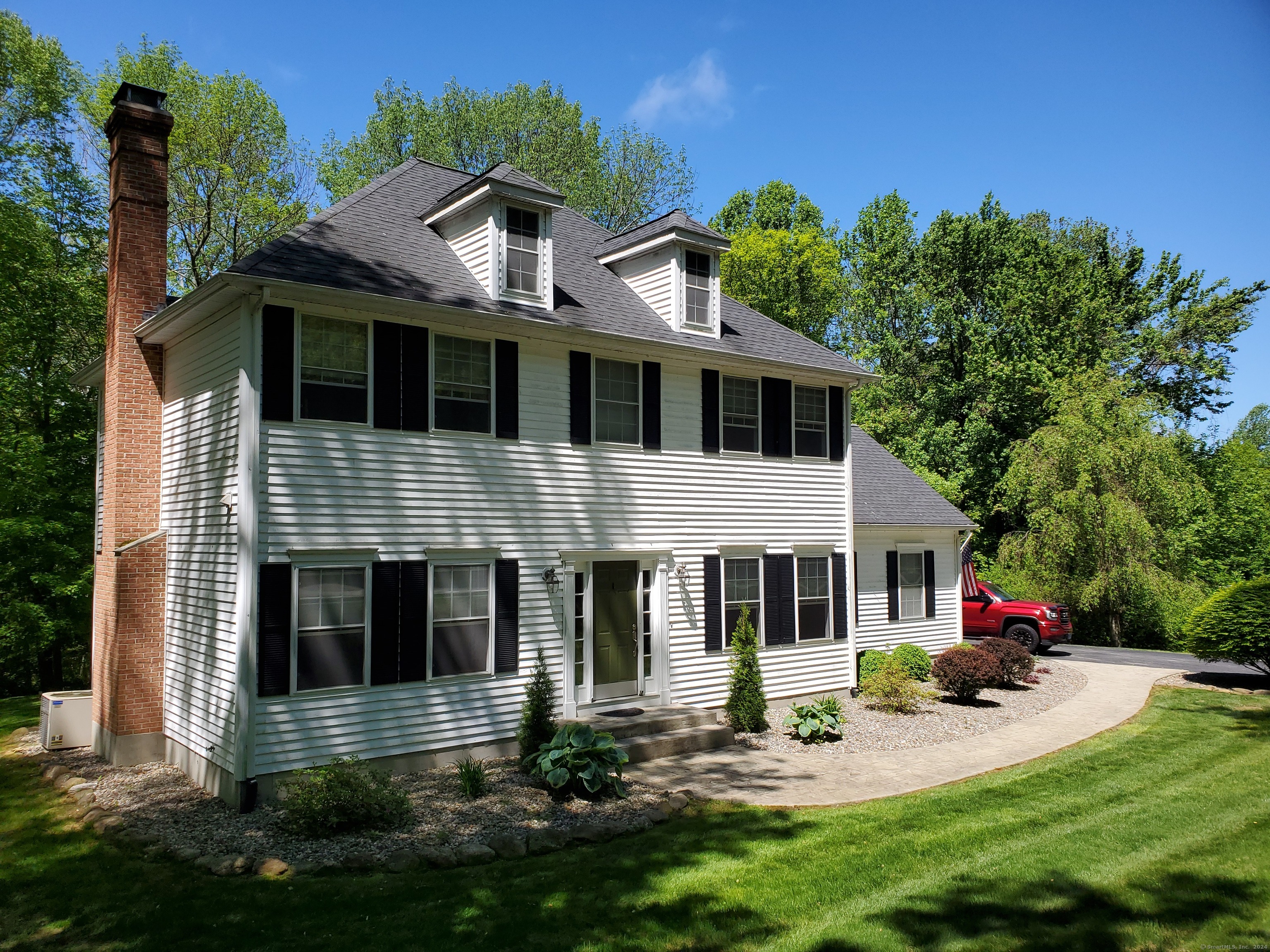 a front view of house with yard and green space