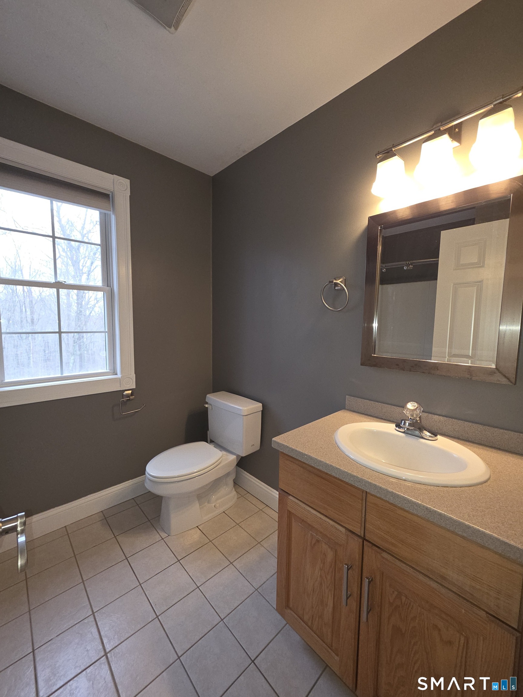 120 Woodbine Road Colchester, CT 06415 - Photo 19 of 24 a bathroom with a toilet sink vanity and mirror