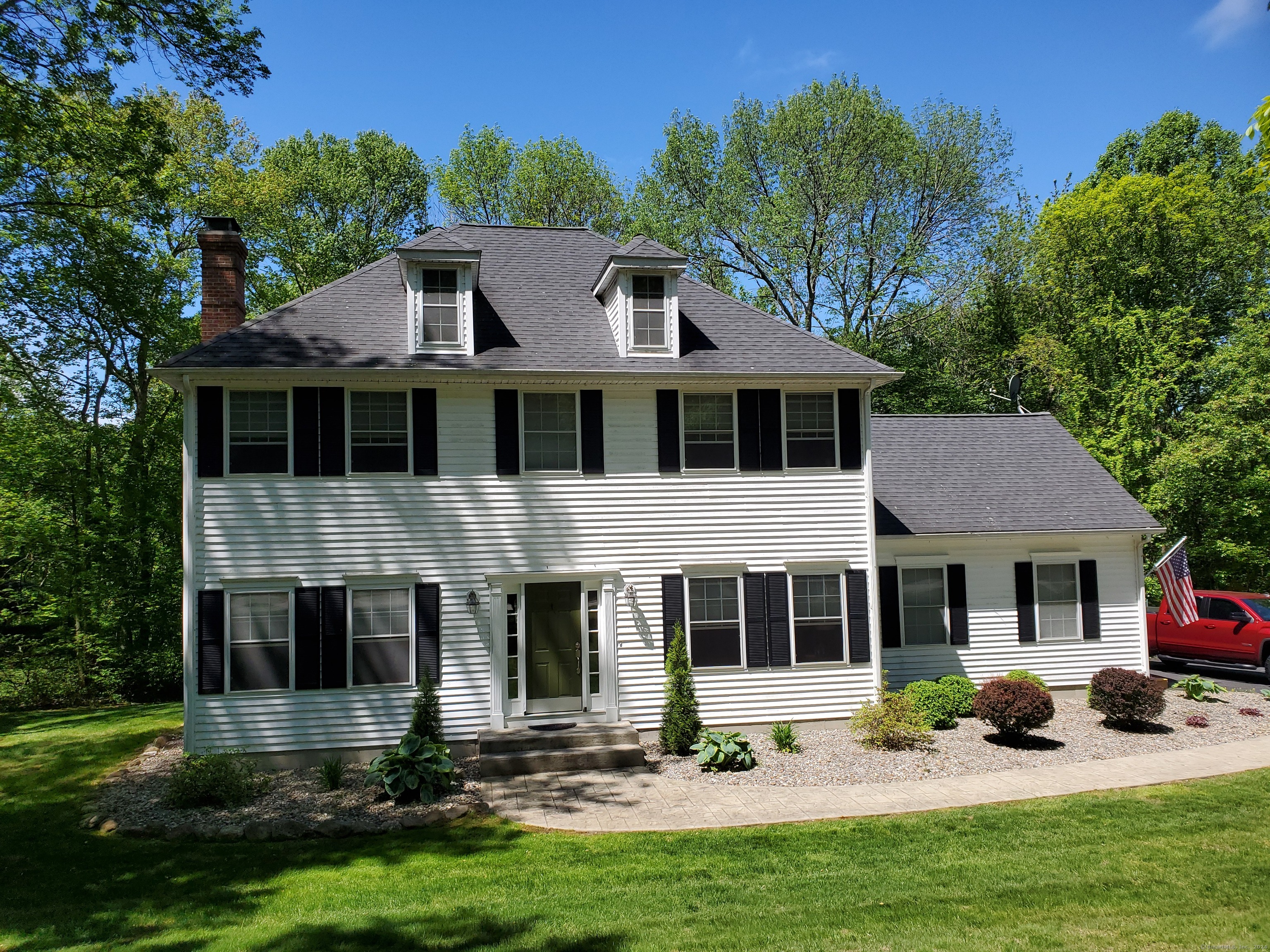 120 Woodbine Road Colchester, CT 06415 - Photo 2 of 24 a front view of a house with a yard and porch