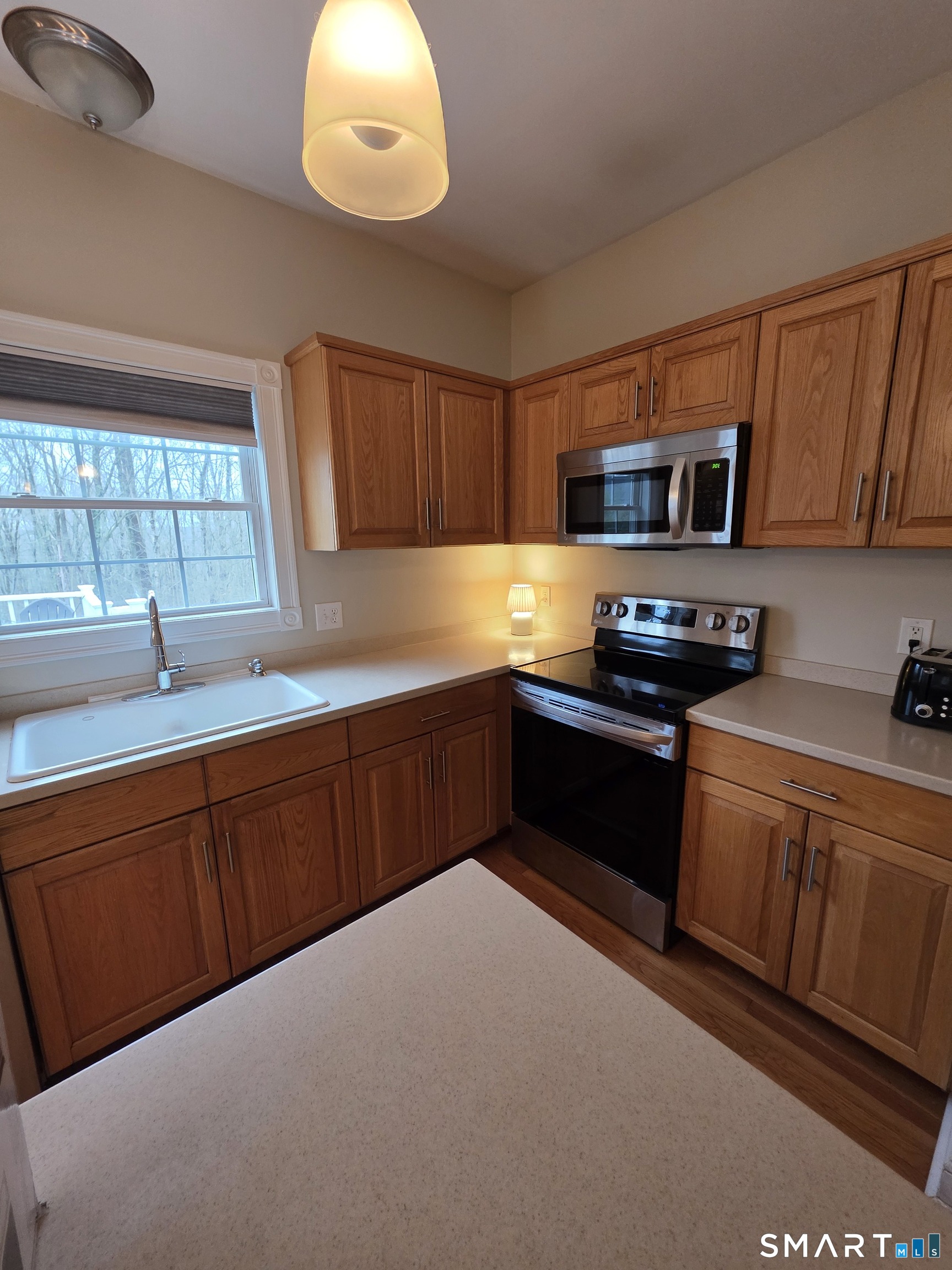 120 Woodbine Road Colchester, CT 06415 - Photo 7 of 24 a kitchen with stainless steel appliances kitchen island granite countertop a sink and cabinets