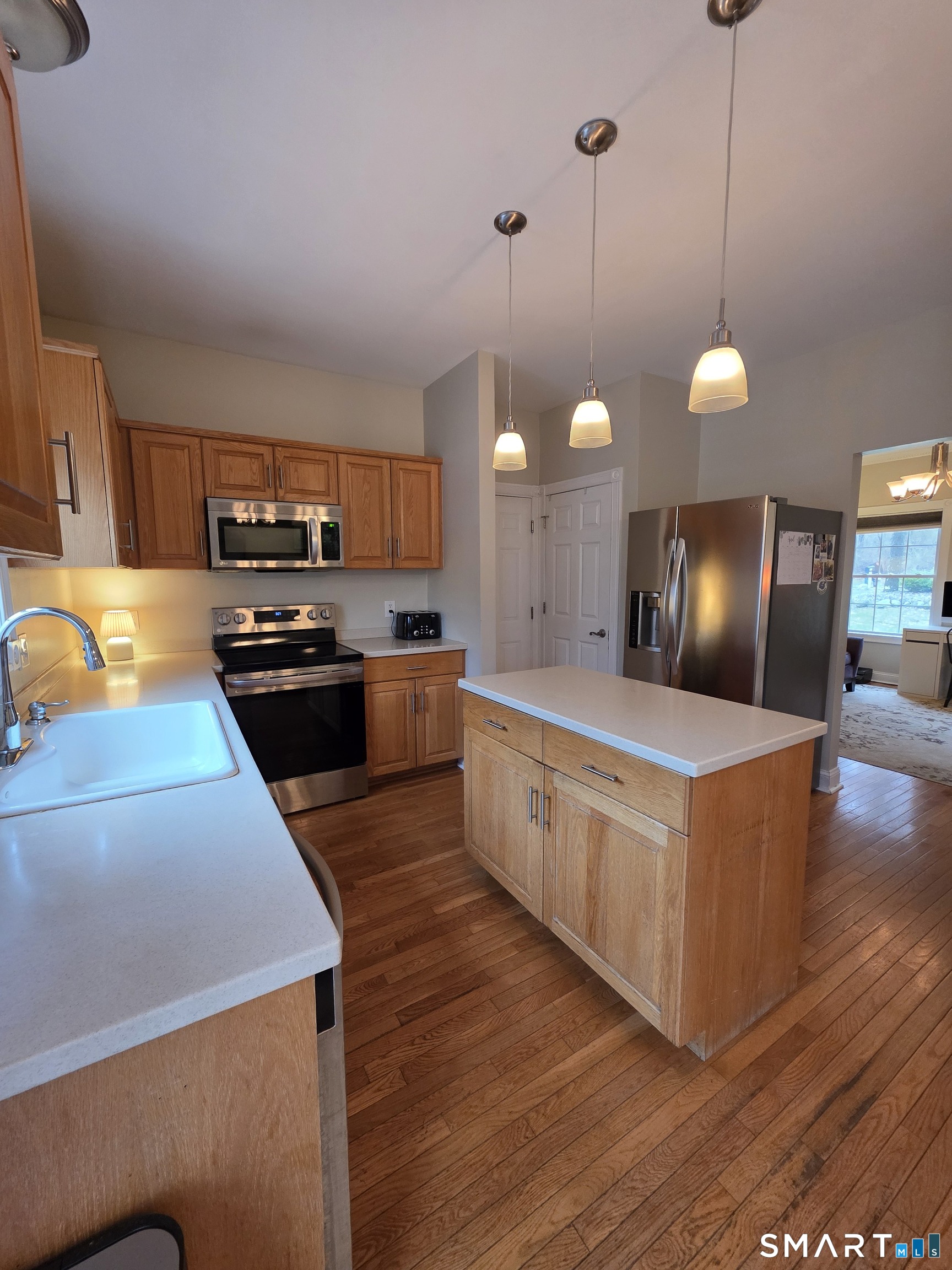 120 Woodbine Road Colchester, CT 06415 - Photo 10 of 24 a large kitchen with stainless steel appliances kitchen island granite countertop a sink a stove and a wooden floor