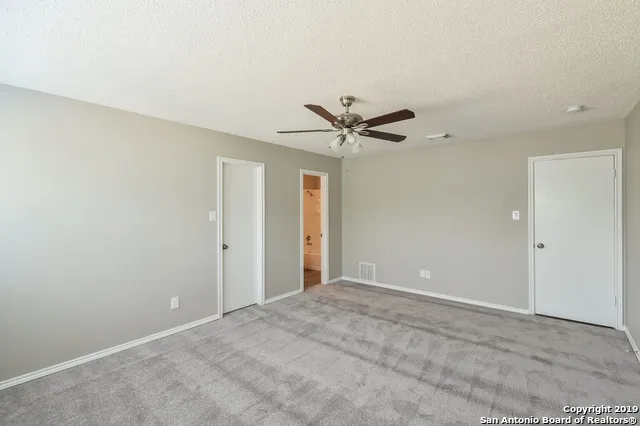 a view of a livingroom with a ceiling fan and window