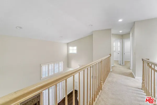 a spacious bedroom with a bed a couch and a window