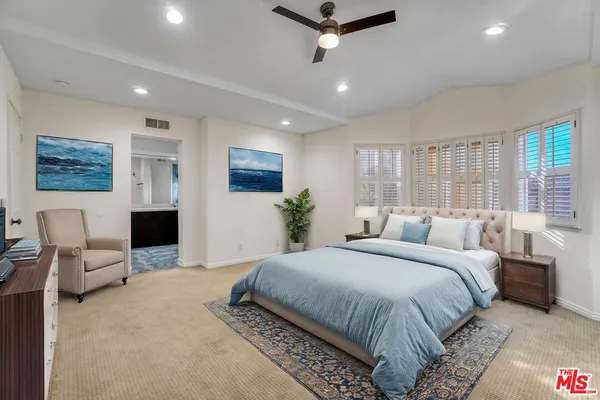 an empty room with windows and fireplace