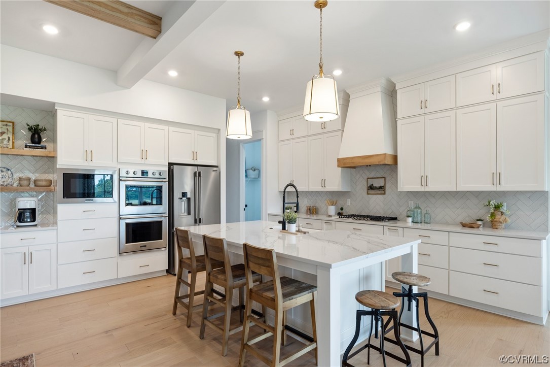 15124 Heaton Drive Midlothian, VA 23112 - Photo 11 of 49 a kitchen with stainless steel appliances kitchen island granite countertop a table chairs and a refrigerator