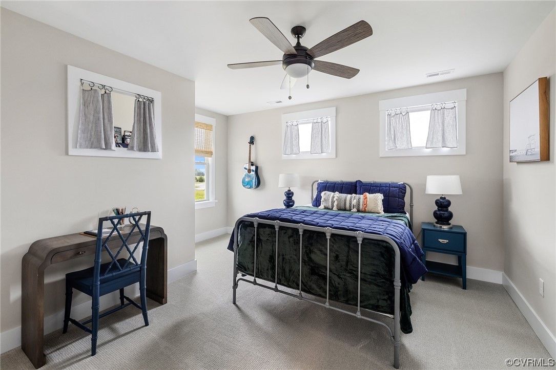 15124 Heaton Drive Midlothian, VA 23112 - Photo 28 of 49 a bed sitting in a bedroom next to a window with a lamp on a dresser
