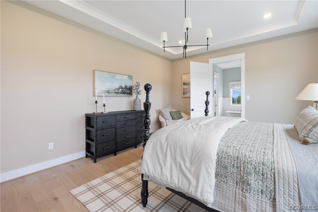 15124 Heaton Drive Midlothian, VA 23112 - Photo 38 of 49 a spacious bedroom with a bed and a chandelier