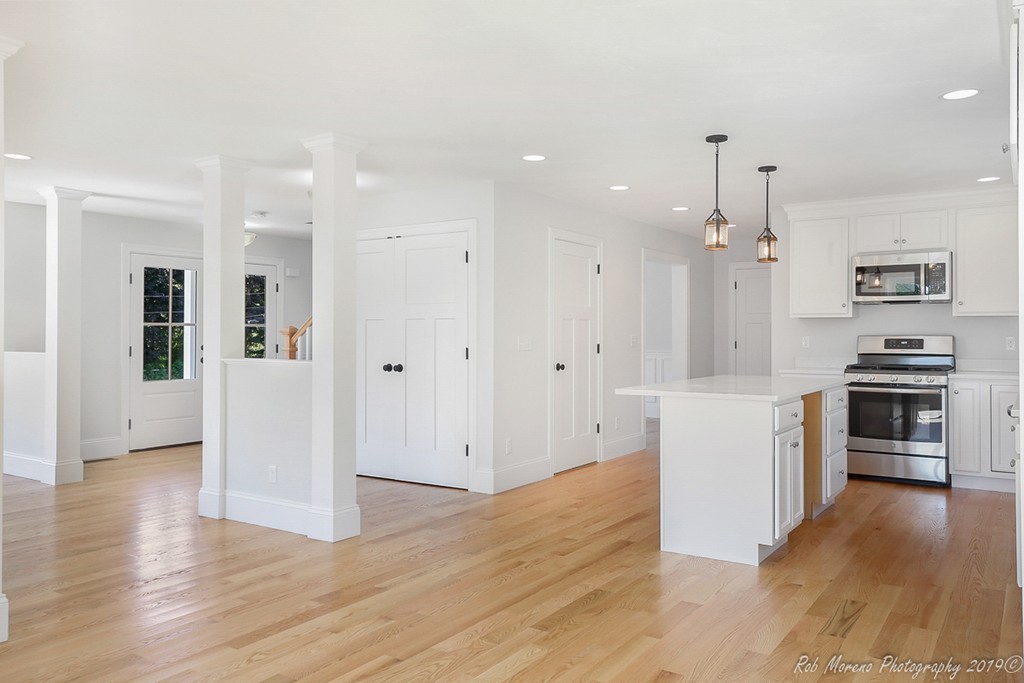 116 Bennett Hill Road Rowley, MA 01969 - Photo 11 of 39 a kitchen with kitchen island white cabinets and stainless steel appliances