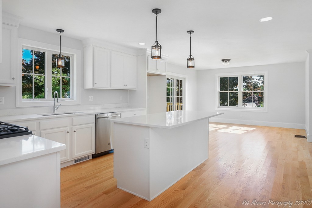 116 Bennett Hill Road Rowley, MA 01969 - Photo 13 of 39 a kitchen that has a lot of white cabinets and wooden floor