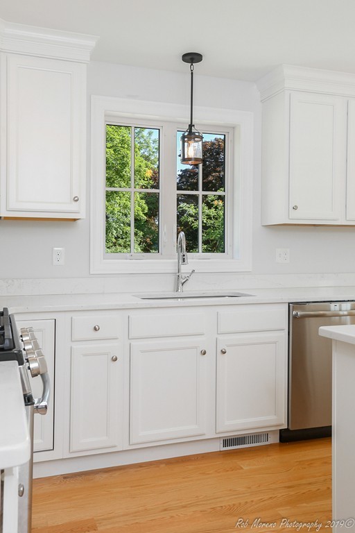 116 Bennett Hill Road Rowley, MA 01969 - Photo 14 of 39 a kitchen with white cabinets and a window