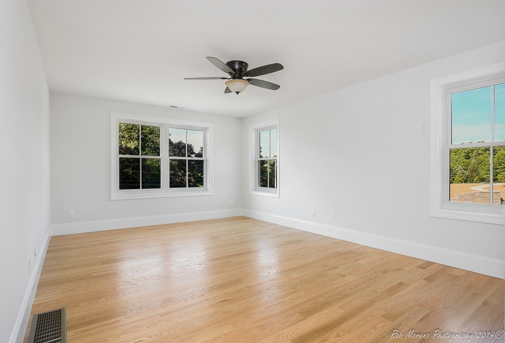 116 Bennett Hill Road Rowley, MA 01969 - Photo 20 of 39 a view of empty room with wooden floor and fan