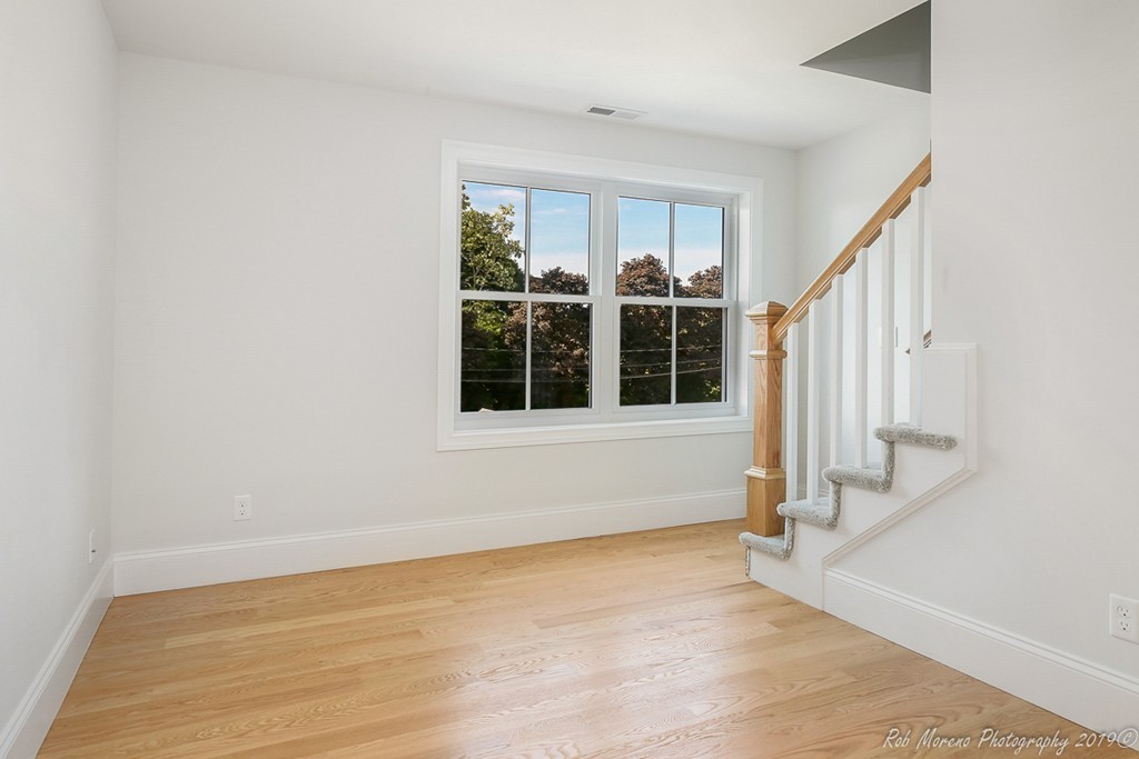116 Bennett Hill Road Rowley, MA 01969 - Photo 27 of 39 an empty room with wooden floor and windows