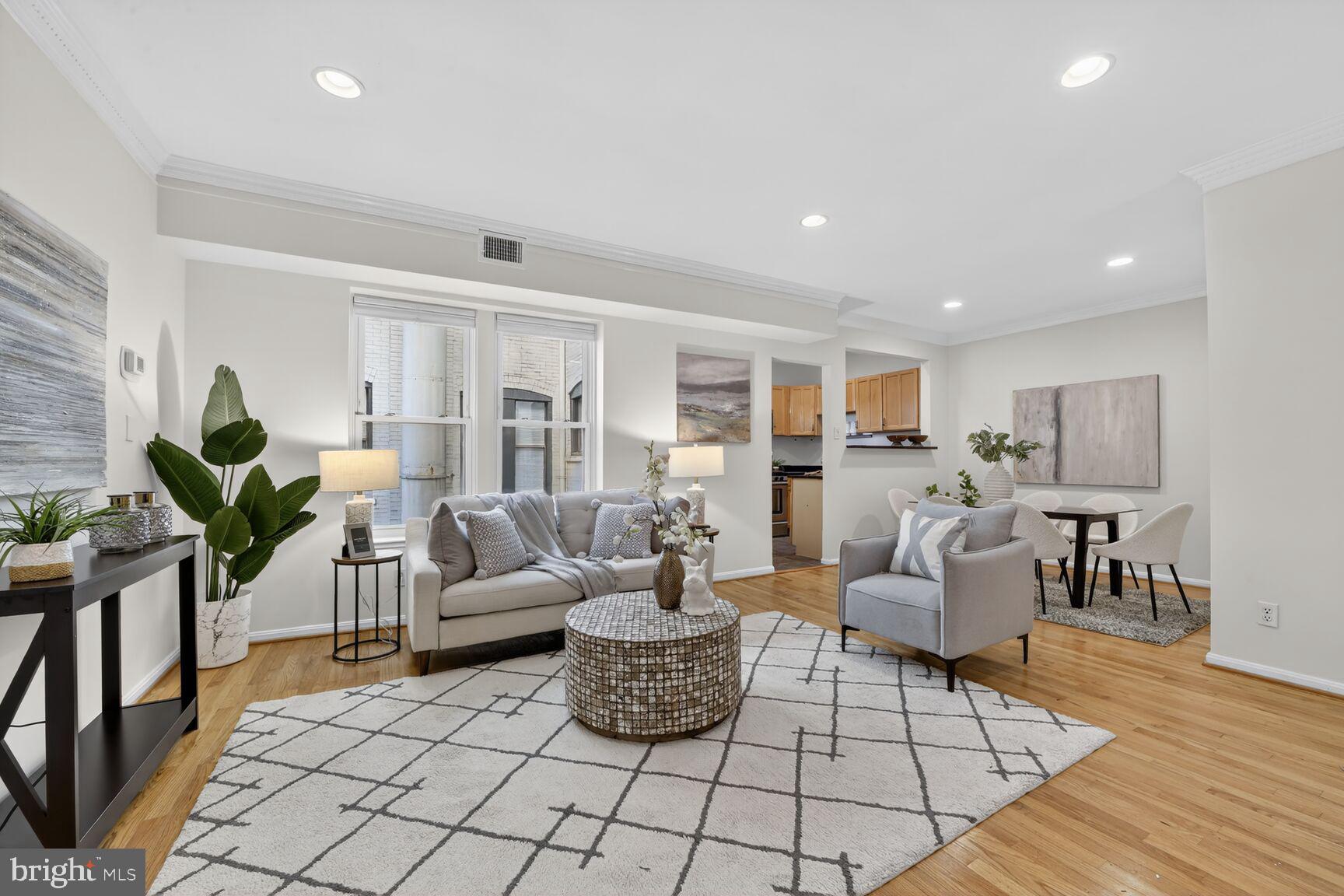 1669 Columbia Road Northwest, Unit 313 Washington, DC 20009 - Photo 1 of 20 a living room with furniture and wooden floor