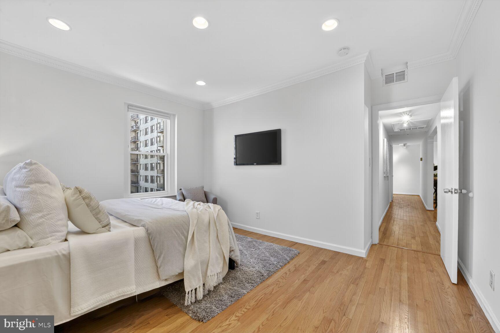 1669 Columbia Road Northwest, Unit 313 Washington, DC 20009 - Photo 17 of 20 a bedroom with a bed and a flat screen tv