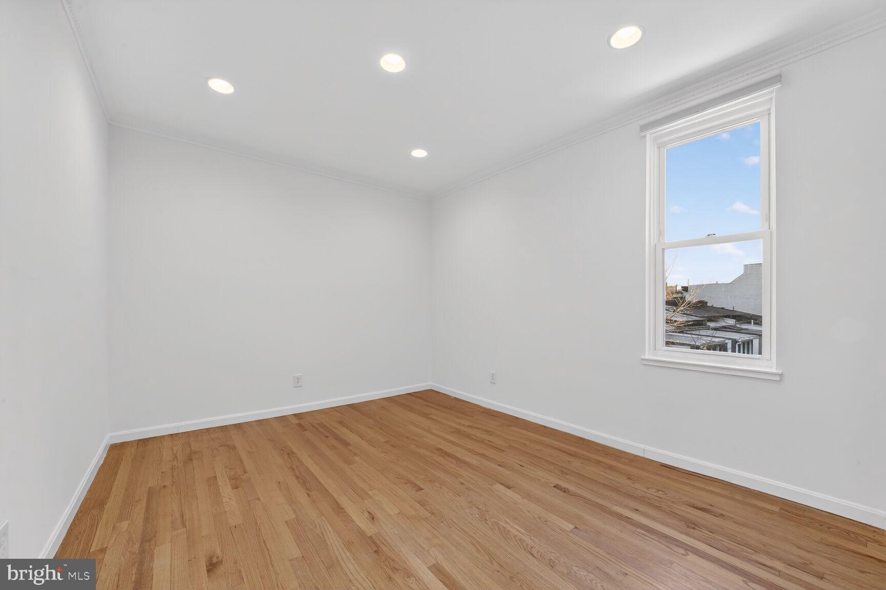 1669 Columbia Road Northwest, Unit 313 Washington, DC 20009 - Photo 18 of 20 a view of a room with wooden floor and white walls