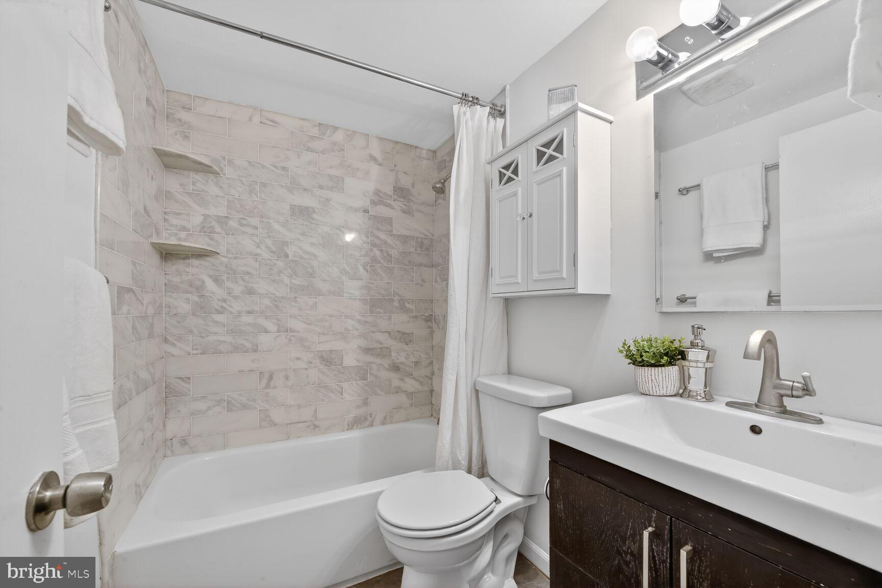 1669 Columbia Road Northwest, Unit 313 Washington, DC 20009 - Photo 19 of 20 a bathroom with a sink toilet tub and shower