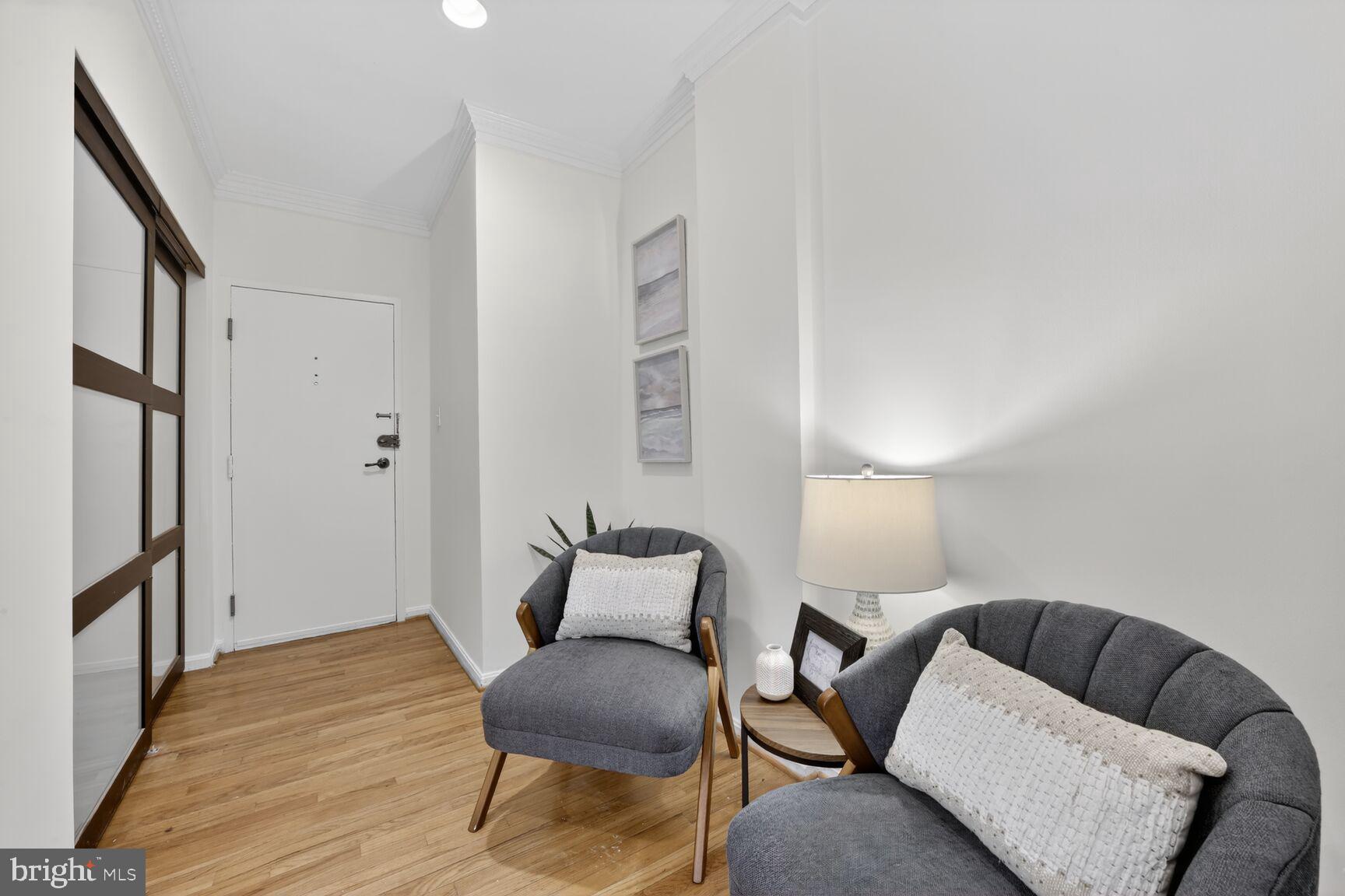1669 Columbia Road Northwest, Unit 313 Washington, DC 20009 - Photo 4 of 20 a living room with furniture and a wooden floor