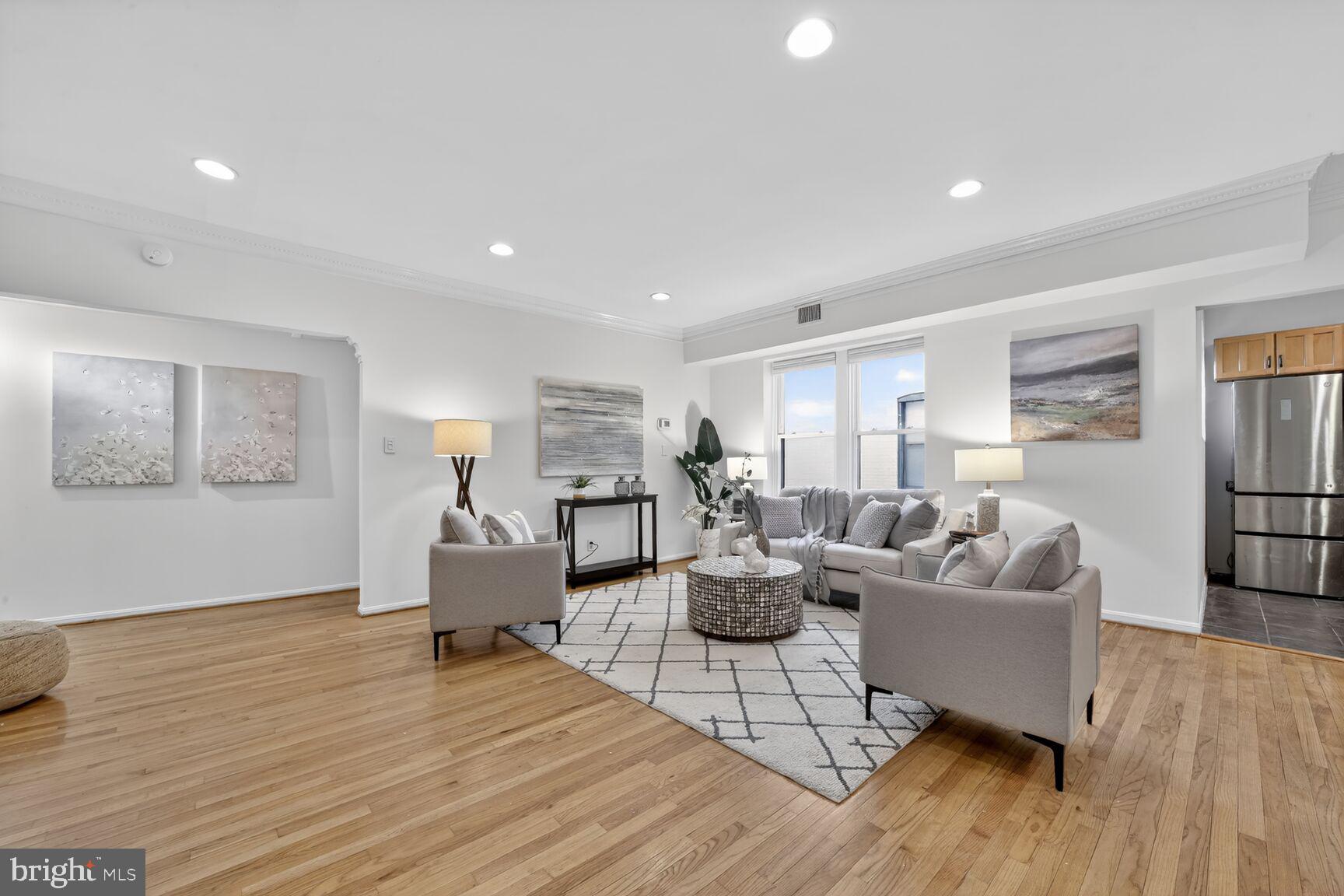 1669 Columbia Road Northwest, Unit 313 Washington, DC 20009 - Photo 5 of 20 a living room with furniture and a wooden floor