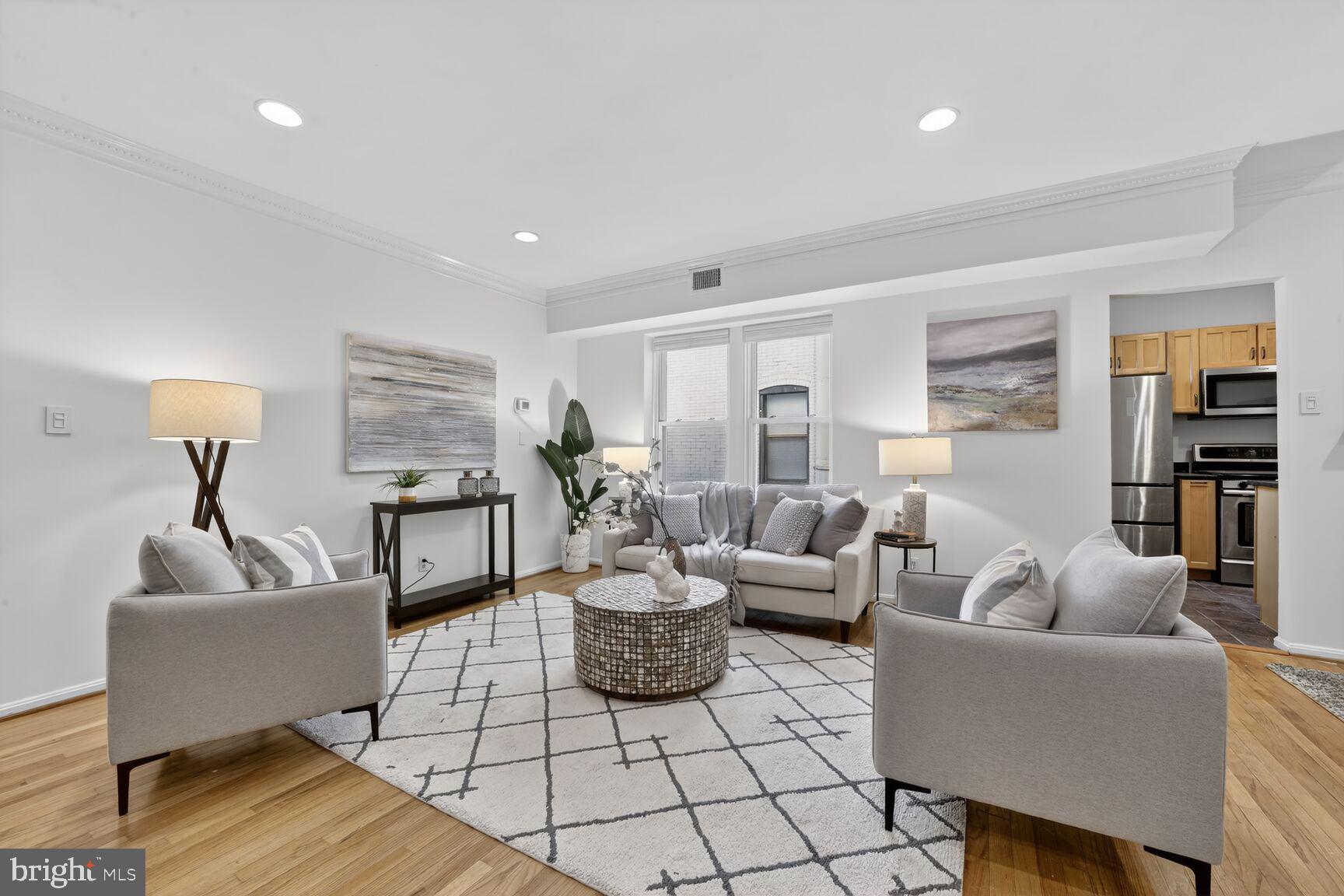 1669 Columbia Road Northwest, Unit 313 Washington, DC 20009 - Photo 6 of 20 a living room with furniture and a wooden floor