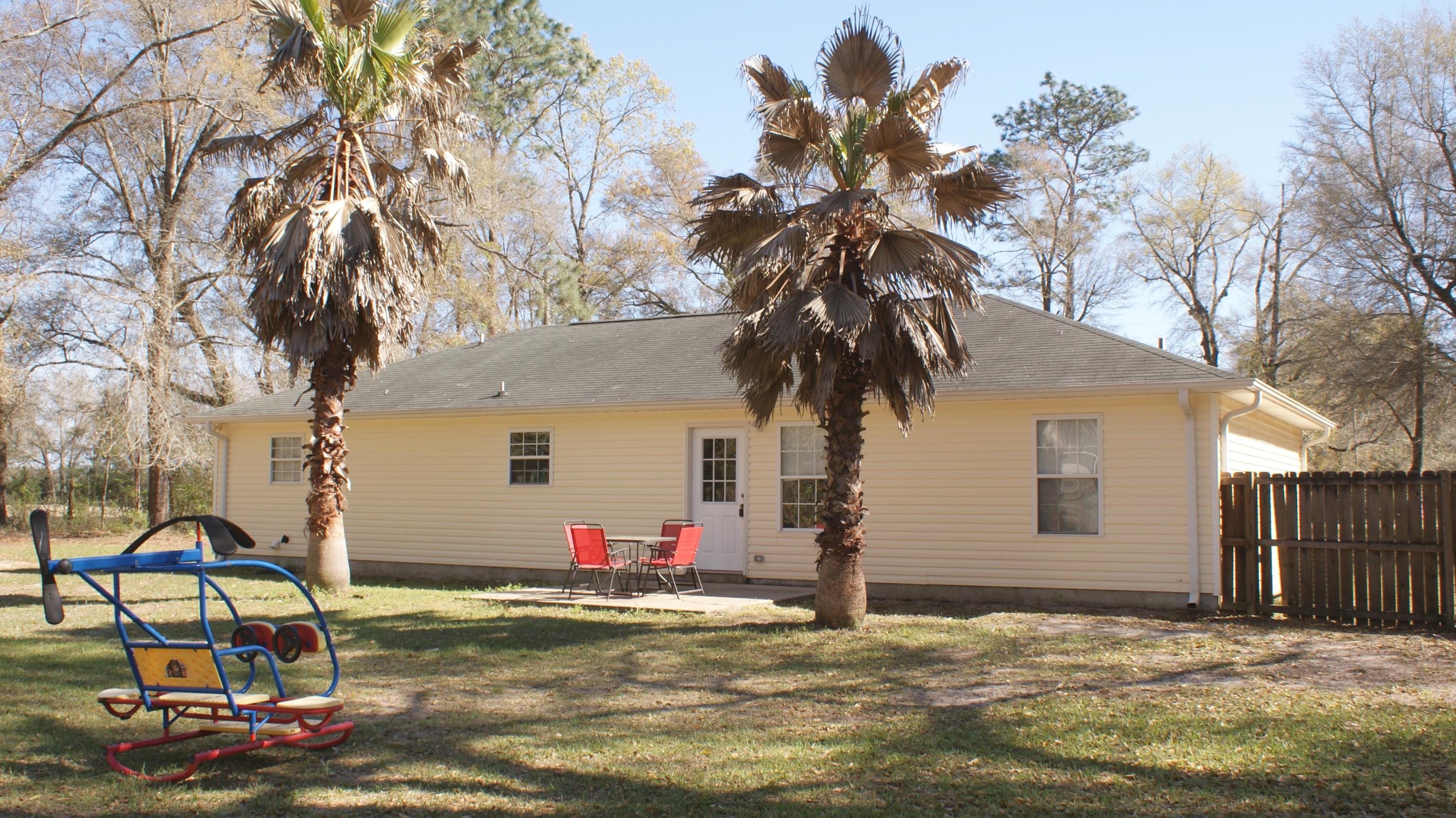 897 Lighthouse Church Road Holt, FL 32564 - Photo 14 of 15 a backyard of a house with table and chairs