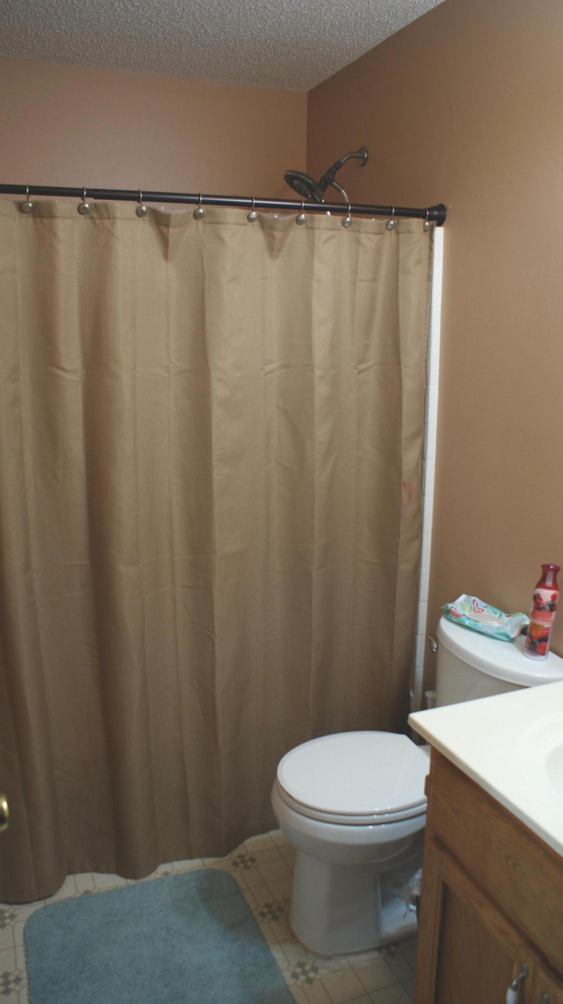 897 Lighthouse Church Road Holt, FL 32564 - Photo 7 of 15 a white toilet sitting next to a shower curtain