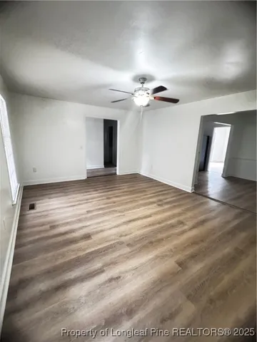a view of hallway with wooden floor
