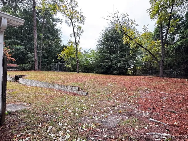 a view of backyard with large trees