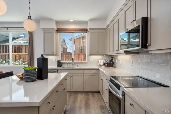 a kitchen with a sink a stove and cabinets