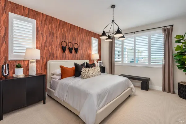 a bedroom with a large bed and a window