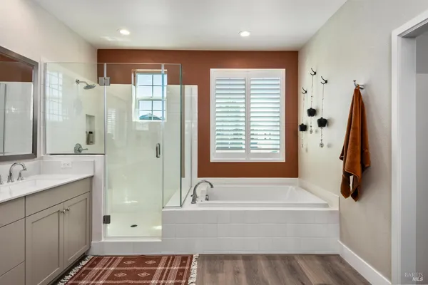 a bath room with a bath tub and a shower