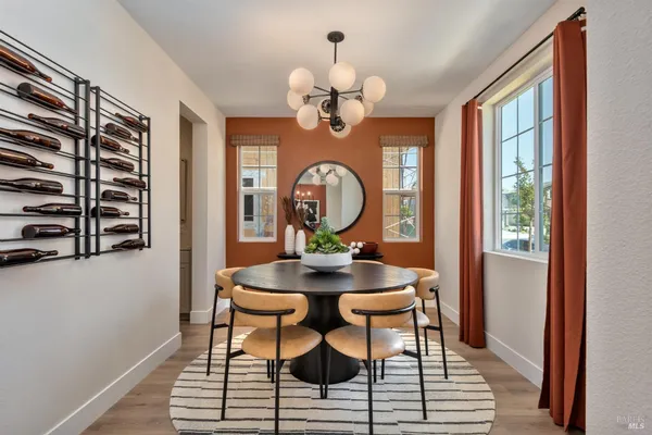 a view of a dining room with furniture and chandelier