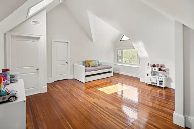 a bedroom with furniture and a wooden floor