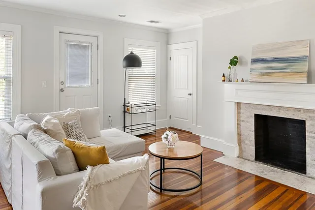 a living room with furniture and a fireplace