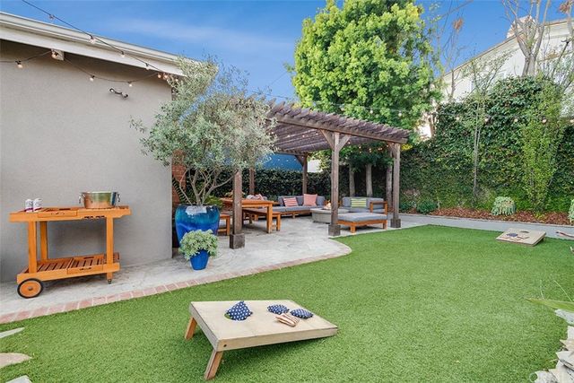 a backyard of a house with table and chairs