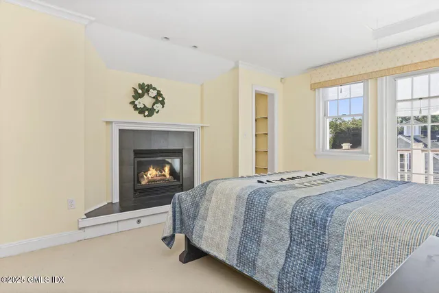 a bed sitting in a bedroom next to a window