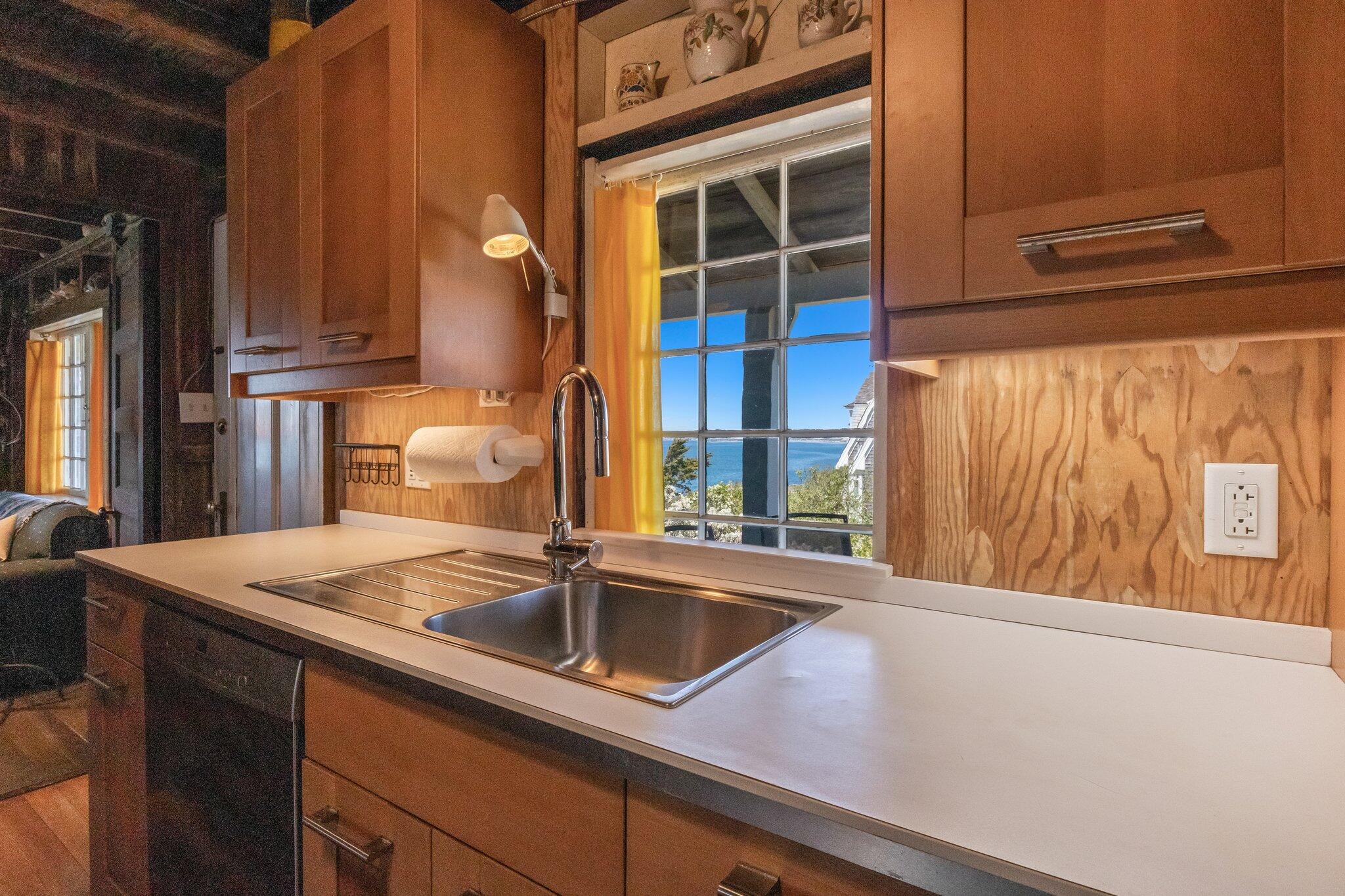 8 Pilgrims Path Truro, MA 02666 - Photo 19 of 49 a kitchen with a sink and a refrigerator