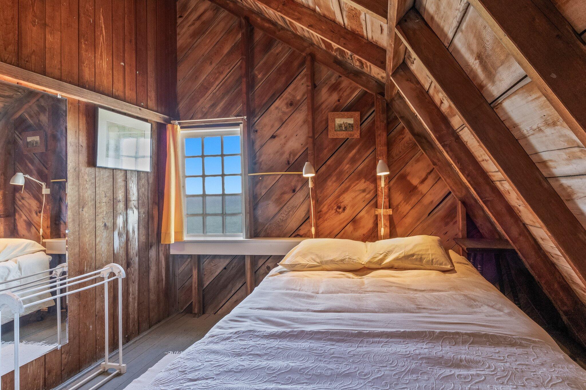 8 Pilgrims Path Truro, MA 02666 - Photo 23 of 49 a bedroom with a bed and wooden floor