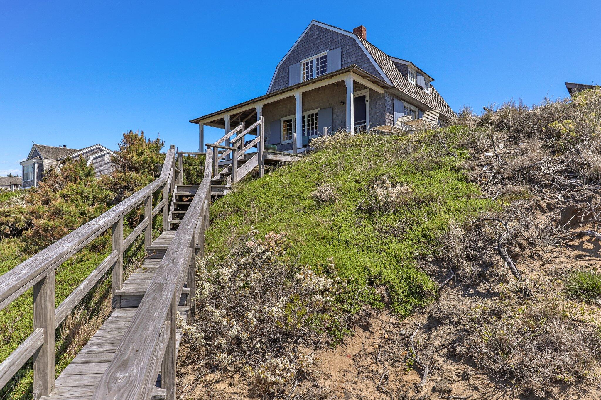 8 Pilgrims Path Truro, MA 02666 - Photo 5 of 49 a front view of a house with a yard