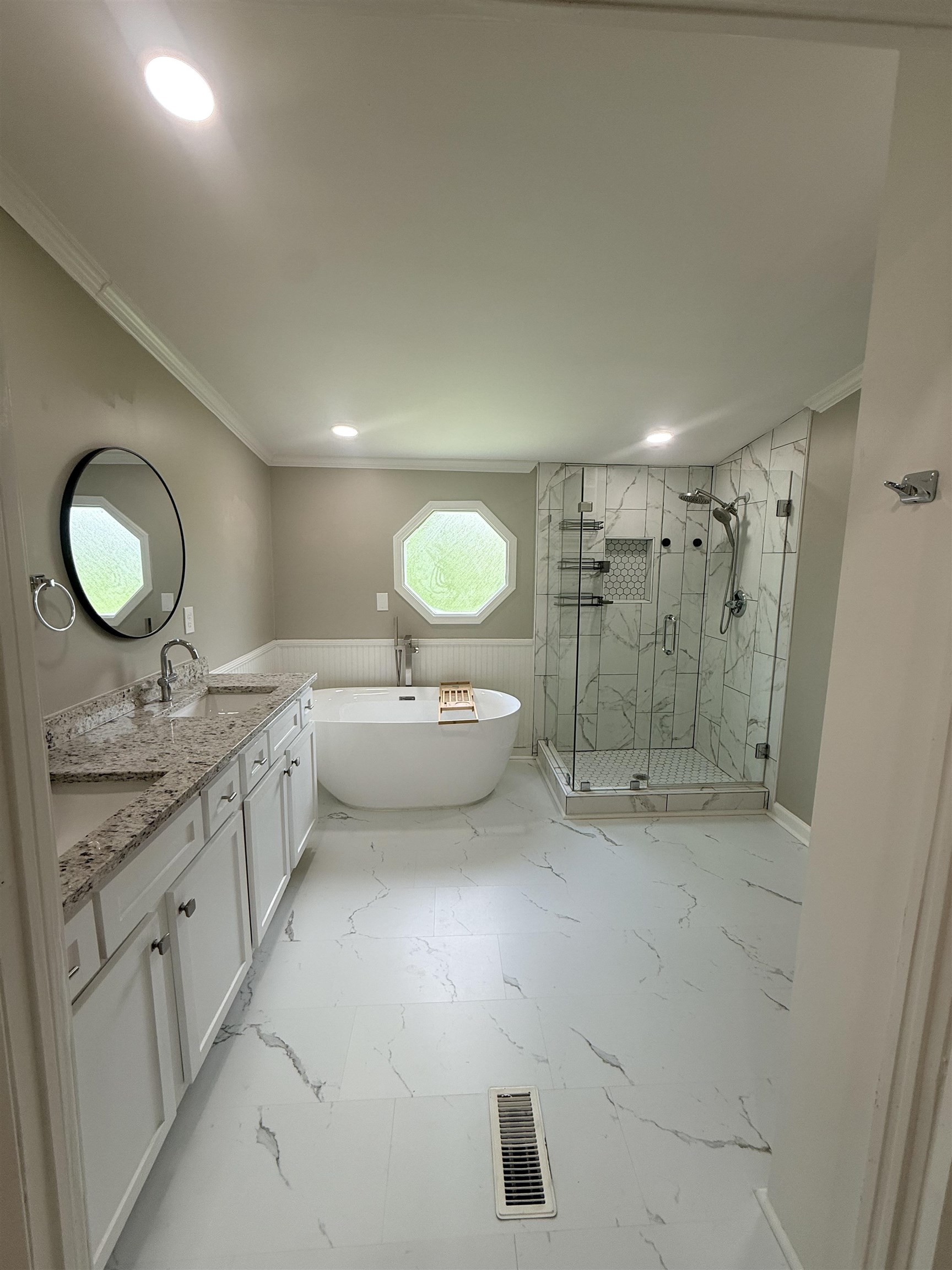229 Coats Road Brighton, TN 38011 - Photo 7 of 14 Bathroom featuring a dual vanity with granite countertops, a freestanding soaking tub, a glass-enclosed shower with multiple shower heads, recessed lighting, and a distinctive octagonal window