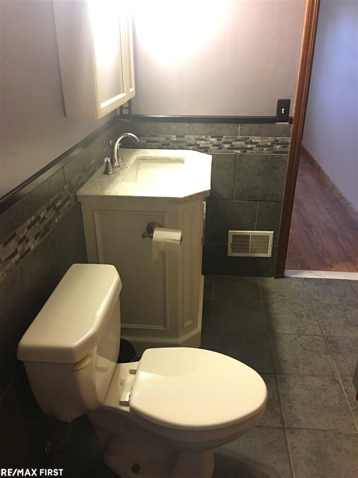 20700 Dunham Road Clinton Township, MI 48038 - Photo 24 of 36 New ceramic tile, shower, sink and cabinet.