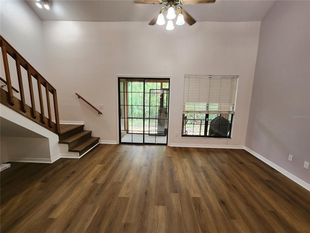 5823 Southwest 9th Place, Unit H55 Gainesville, FL 32607 - Photo 24 of 50 wooden floor in an empty room with a window
