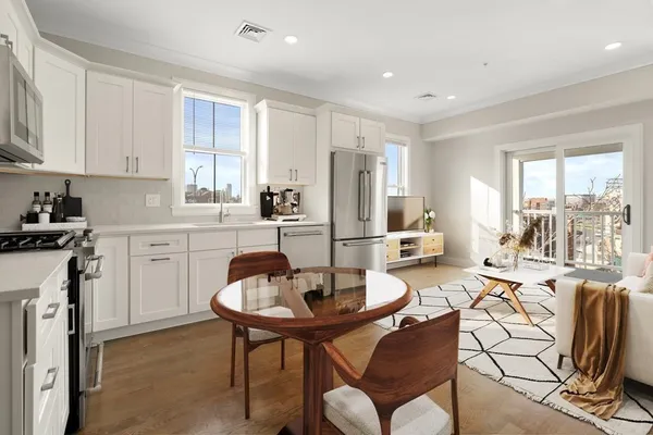 a view of a dining room with furniture and a kitchen