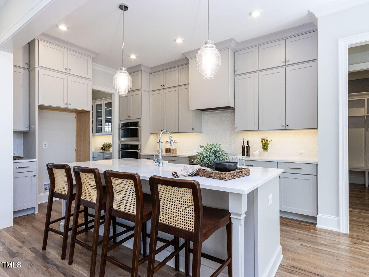 809 St Charles Street Durham, NC 27713 - Photo 13 of 43 a kitchen with stainless steel appliances kitchen island granite countertop a dining table chairs and white cabinets